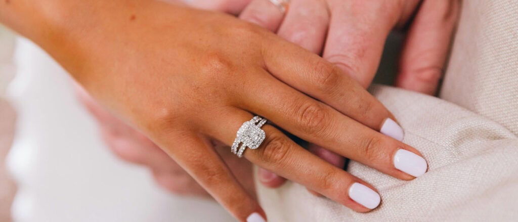 Luxurious lab-grown diamond engagement ring on woman's hand, eco-friendly and conflict-free jewelry.
