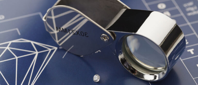 Lab-grown diamond under magnifying glass showcasing real stories behind ethical jewelry.