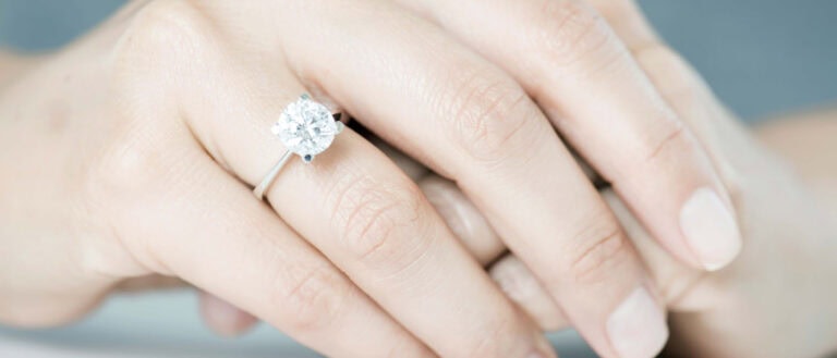 Stunning lab-grown diamond ring on a woman's finger, showcasing personal stories behind ethical diamonds.