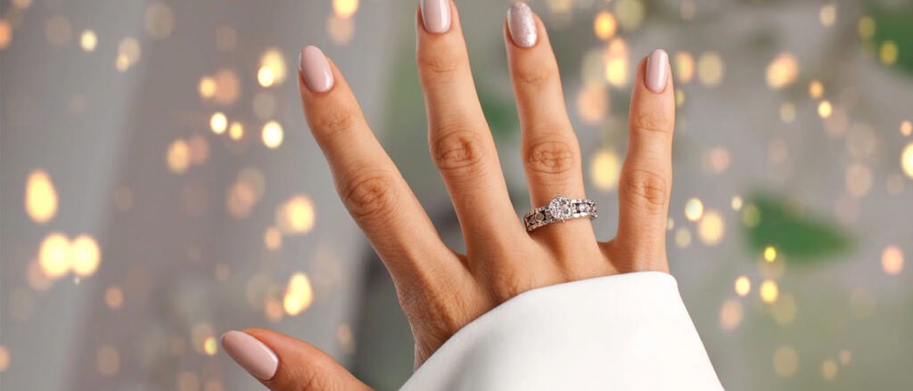 Vegan lab-grown diamond engagement ring on a woman's hand, modern ethical jewelry.
